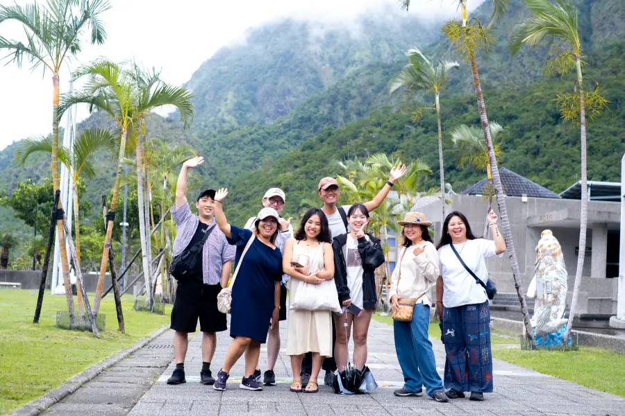 A group waving by the Taitung coast and mountains