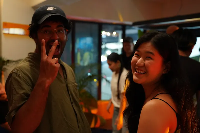 Two guests smile for the camera during a lively evening of conversation
